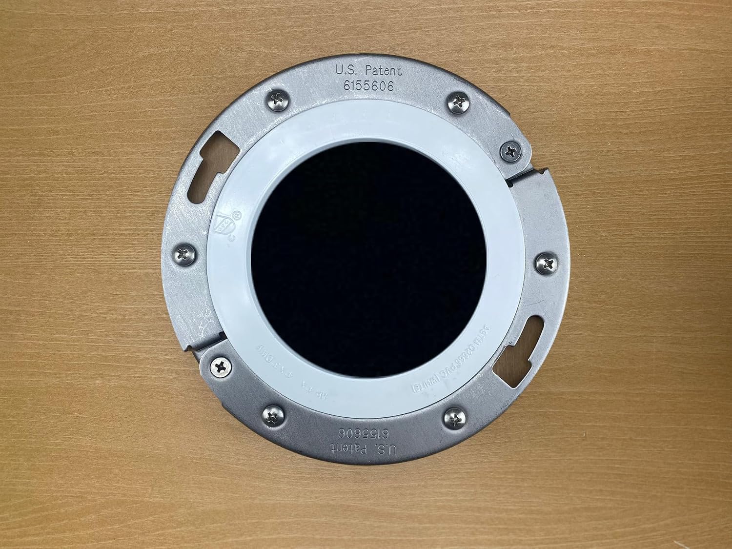 The Clam installed over an existing closet flange with U.S. patent visible